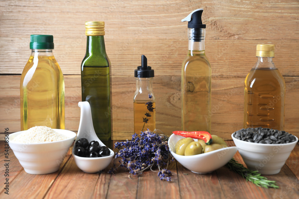 Different cooking oils and ingredients on wooden table Different cooking oils and ingredients on wooden table