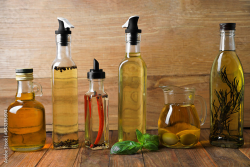 Many different cooking oils on wooden table