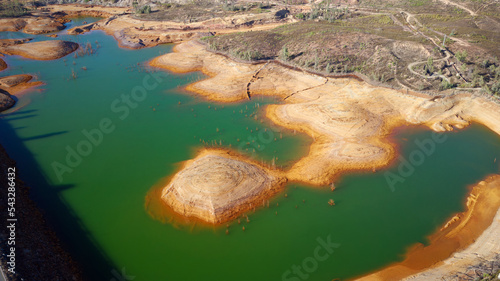 Aerial drone view of Mining activity in Minas de Riotinto in Spain. Polluted lake and water. Drought. Apocalypse scenery. Extractivism. Mining village in Andalusia. Earth destruction. Disruption of na photo