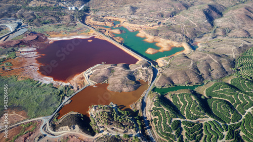 Aerial drone view of Mining activity in Minas de Riotinto in Spain. Polluted lakes and destroyed land. Apocalypse scenery. Extractivism. Mining village in Andalusia. Earth destruction. Disruption. photo
