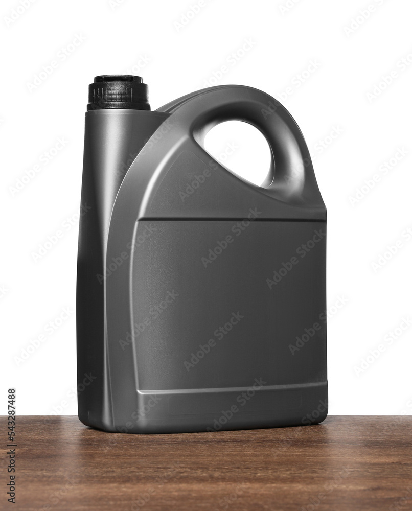 Motor oil in grey container on wooden table against white background Motor oil in grey container on wooden table against white background