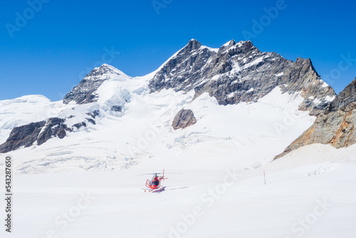 Walkers and climbers on the glacier above the Jungfraujoch station in the swiss alps