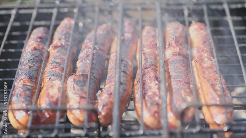 .Frying sausages on the grill outdoors close-up. Grilled sausages,  B-B-Q