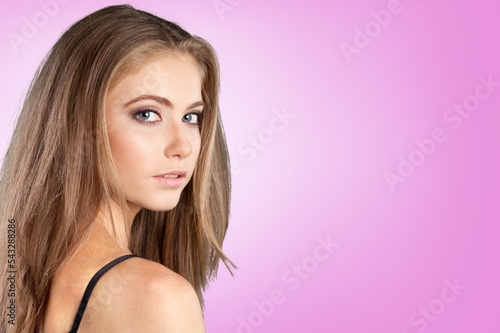 Happy woman with long hair posing on colorful background