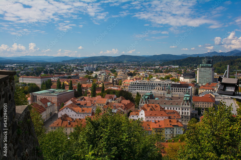 The city of Ljubljana in central Slovenia viewed from the historic castle on Castle Hill. Part of the castle walls can be seen on the left
