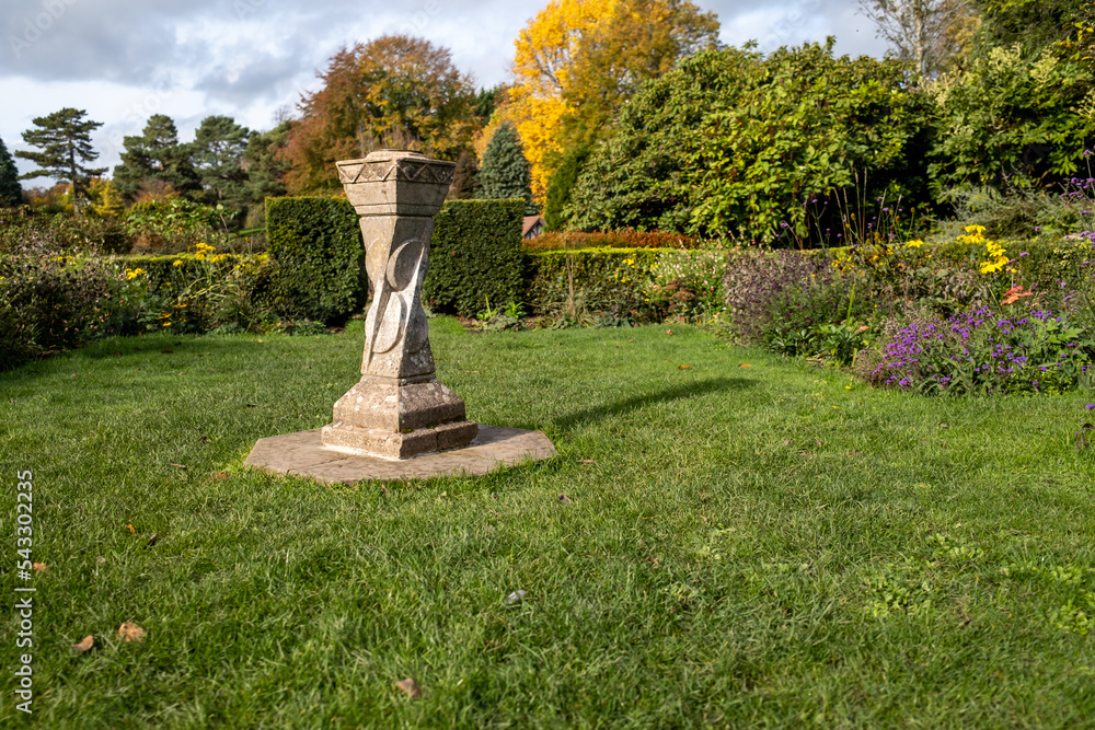 Close and selective focus on a concrete sundial in the garden of a stately home