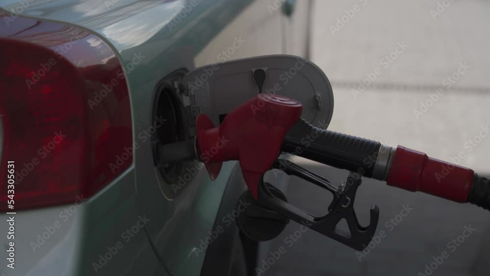 Close up of car refueling at gas station service. Open vehicle fuel