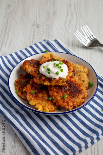 Homemade Fried Cheddar Corn Fritters on a Plate, side view.