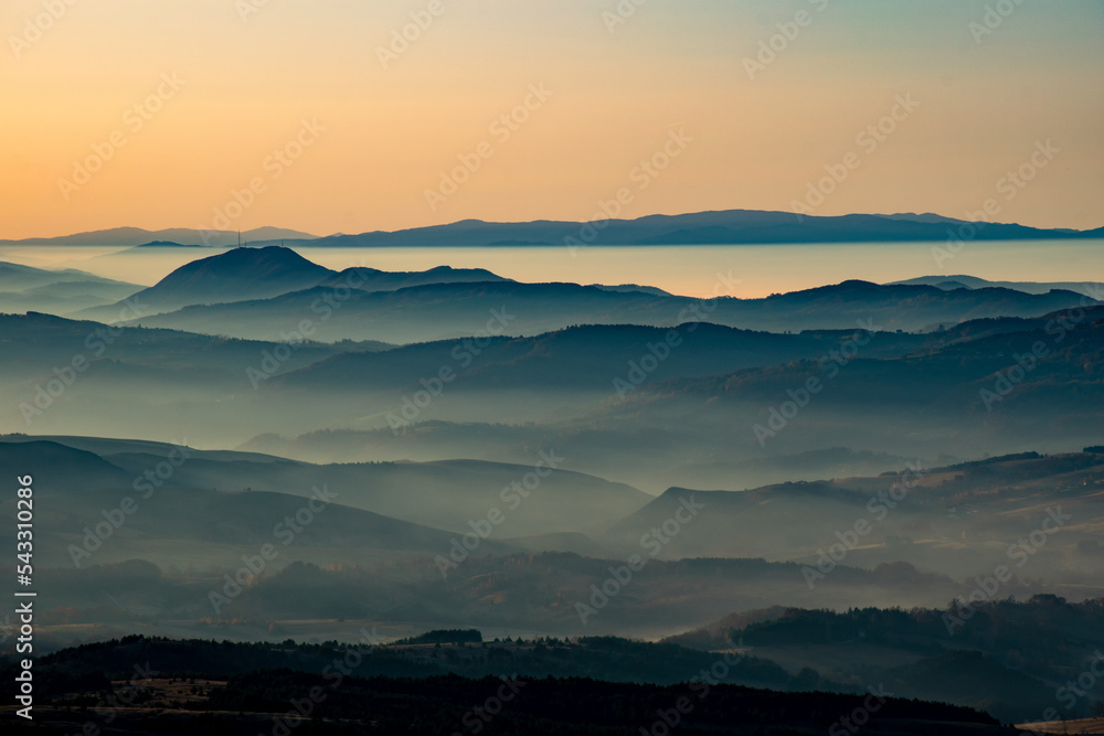 Sunrise in mountains with fog in valleys Sunrise in mountains with fog in valleys