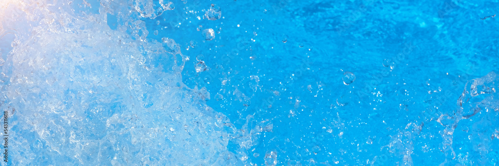 Obraz premium Surface of blue swimming pool water with light reflection, splashes and waves. Texture of transparent blue water with waves in swimming pool. Trendy abstract nature background. long banner.