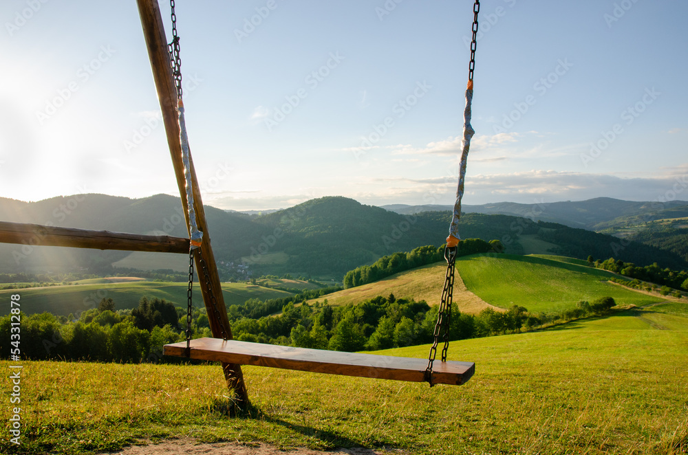 A swing in the mountains inviting you to hop on it. Beautiful Slovak landscape on a such magnificent sunny day.. A swing in the mountains inviting you to hop on it. Beautiful Slovak landscape on a such magnificent sunny day..