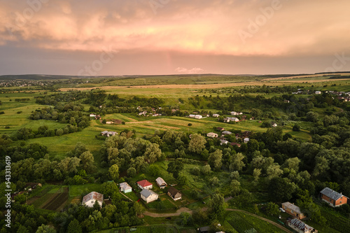 Aerial view of residential houses in suburban rural area at sunset photo