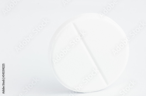 The photo shows one white pill macro