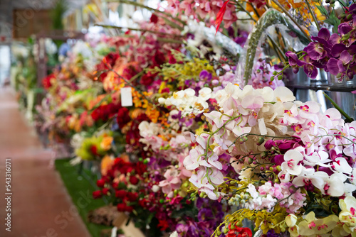 Photography Colorful showcase of flower shop with large assortment of artificial flowers