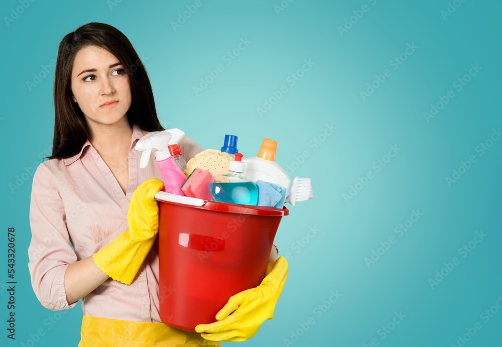 An woman cleaner posing on the background An woman cleaner posing on the background