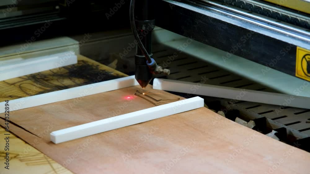 Laser cutting beam high precision on a plywood sheet. Modern technology