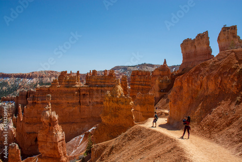 Bryce Canyon National Park, Utah, United States. Hoodoos and rock formations. People walking on trail in Bryce canyon 