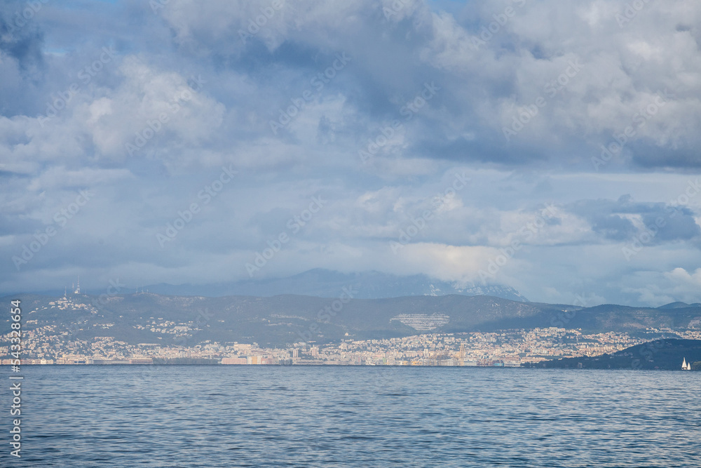 Panorama of the city of Trieste and its port, seen from afar, from the Adriatic Sea. Trieste is an italian city of the Friuli Venezia Giulia province...
