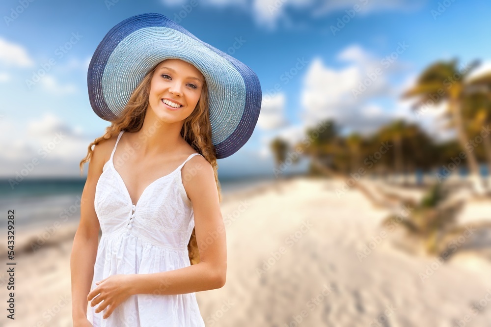 Cheerful woman on the beach on a sunny day. Being active and having fun during summer vacation.