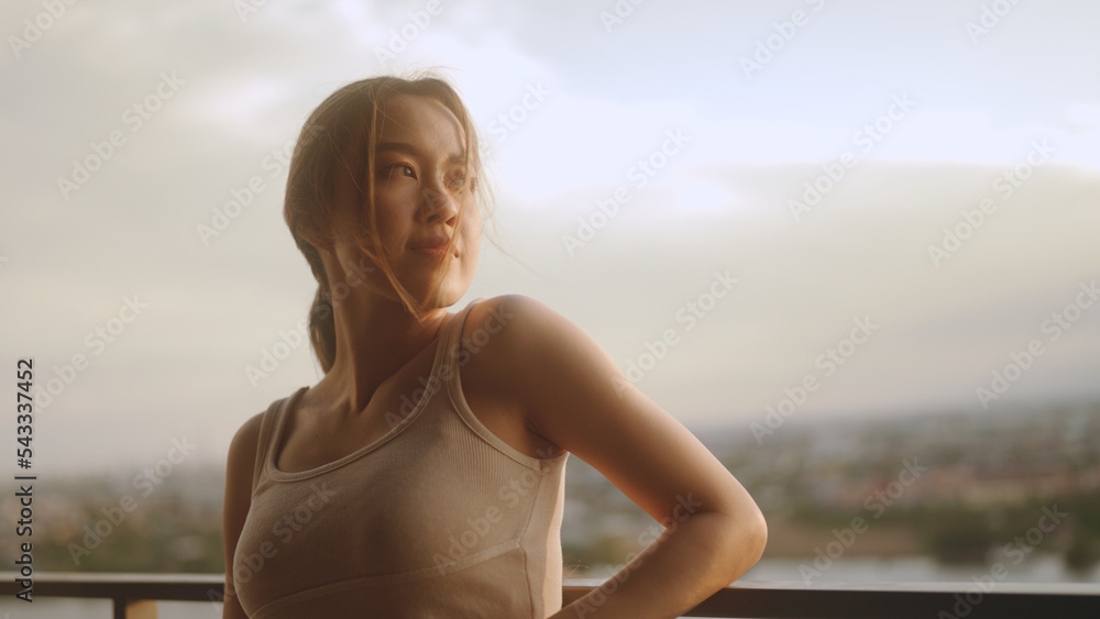 woman enjoying sunlight on balcony