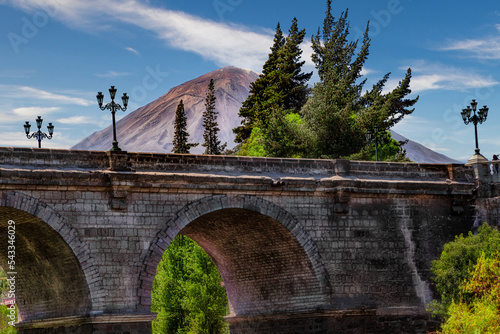 The famous Puente Grau Bridge in Arequipa in Peru with the snowless Misti Volcano in the background. photo
