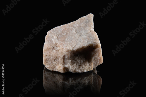 An untreated fragment of the mineral orthoclase with a granular surface of a pinkish color