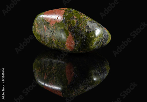A piece of unakite mineral with polished greenish edges photo