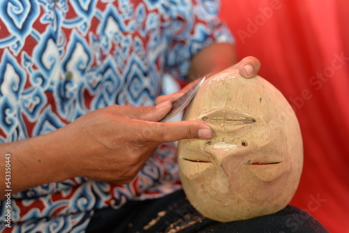 Making Topeng Dance Mask, The Symbol of human life which have 5 type, Panji, Samba, Rumyang, Tumenggung and Kelana. photo