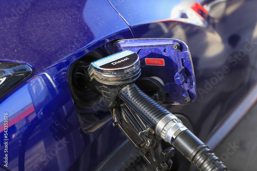 Bild auf Leinwand A car at a gas station is filled up with diesel