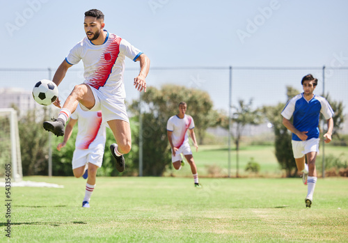 Football, soccer players in match and competition game with professional adult footballers with temwork, passion and athletic skill. Outdoor grass, soccer field with team running to kick soccer ball