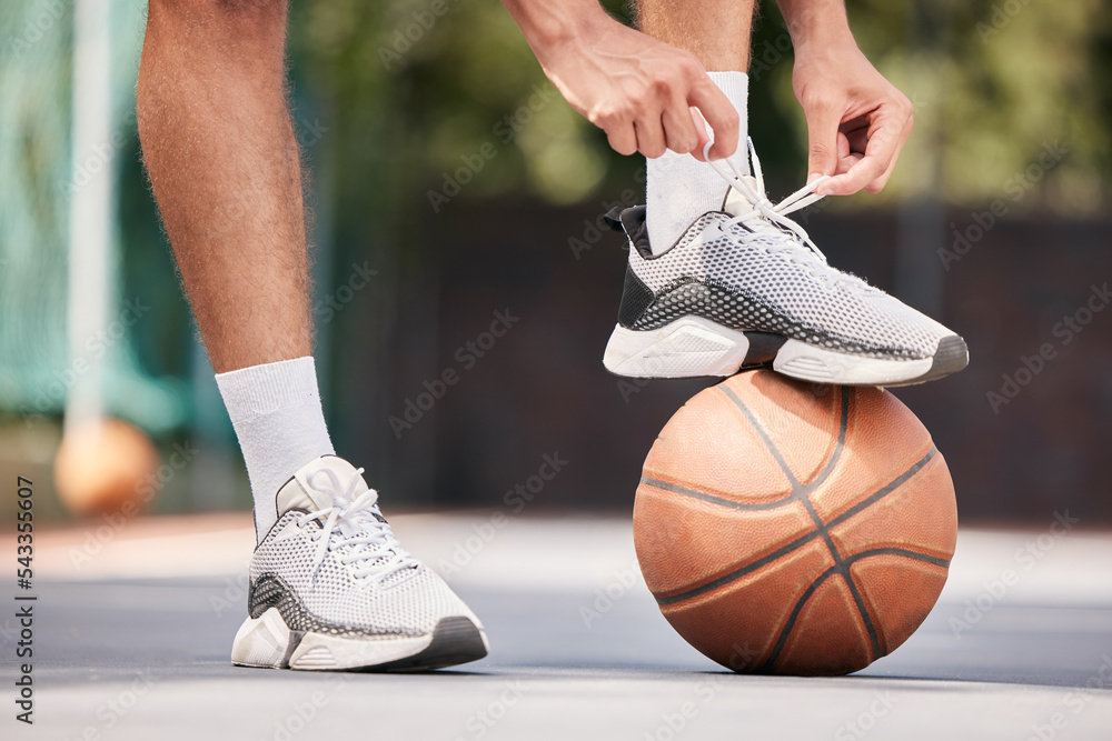 Fototapeta premium Tie shoes, sports and hands on a basketball court getting ready for training, cardio workout and fitness exercise. Footwear, sneakers and healthy athlete in preparation for a practice game or match