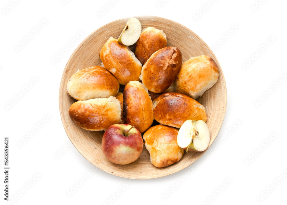 Homemade pies with apples in bamboo basket on white background. Cooking concept. Close-up Homemade pies with apples in bamboo basket on white background. Cooking concept. Close-up