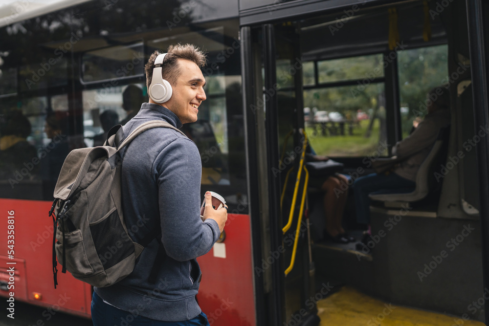 One man young adult male tourist at public transport bus station One man young adult male tourist at public transport bus station