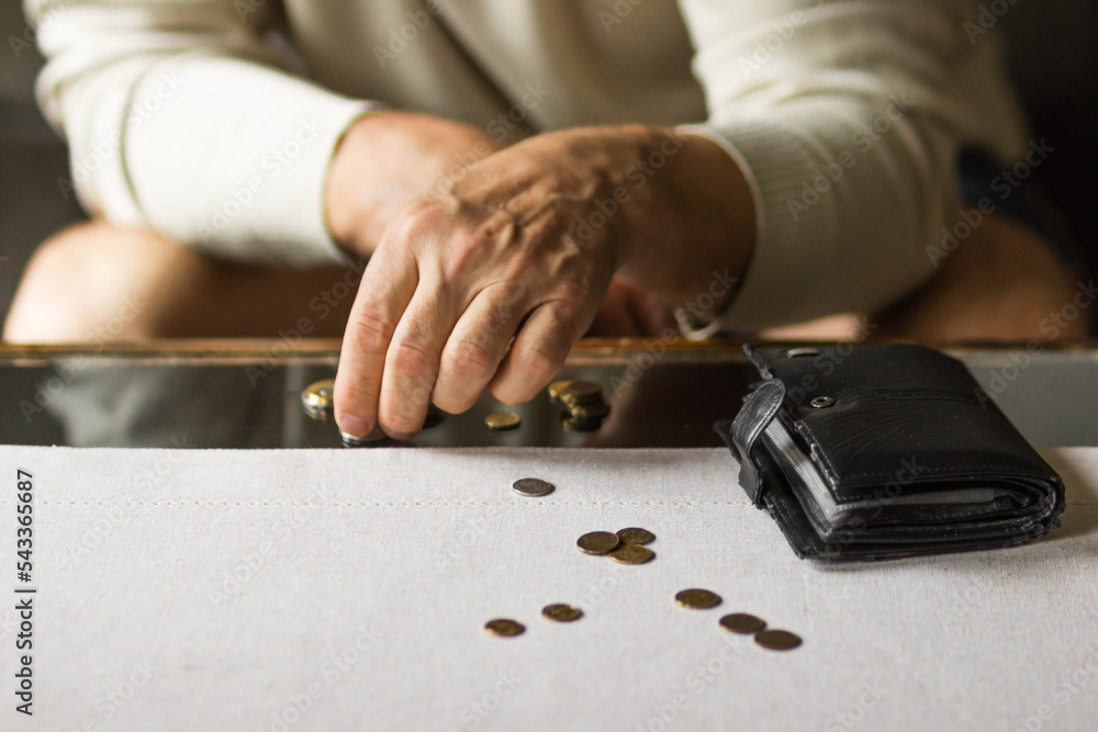 Senior man counting coins on the table with wallet in a period of crisis. Old man's hands stacking poland coins. Poverty Senior man counting coins on the table with wallet in a period of crisis. Old man's hands stacking poland coins. Poverty