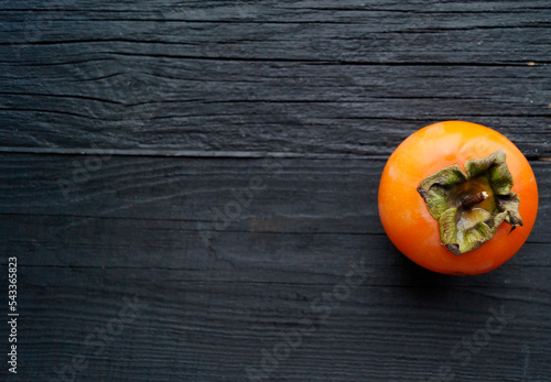 persimmon on wooden table