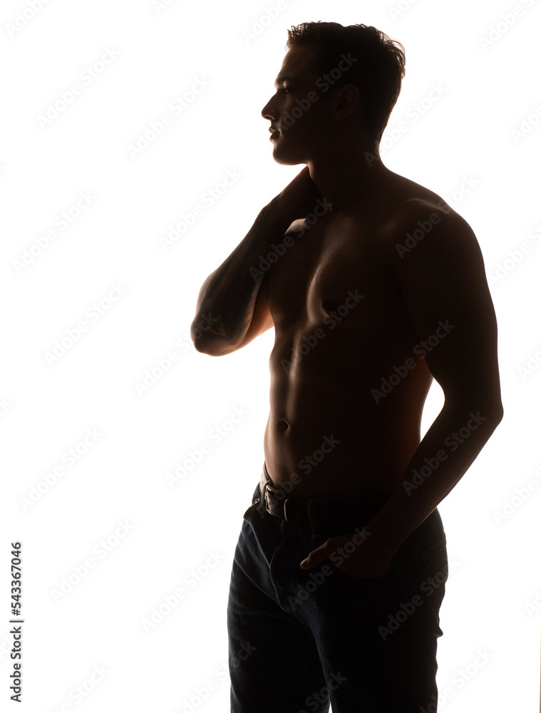 Handsome muscular male model bodybuilder preparing for fitness training turned back