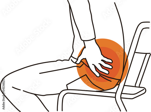 腰痛で腰に手を当てる男性