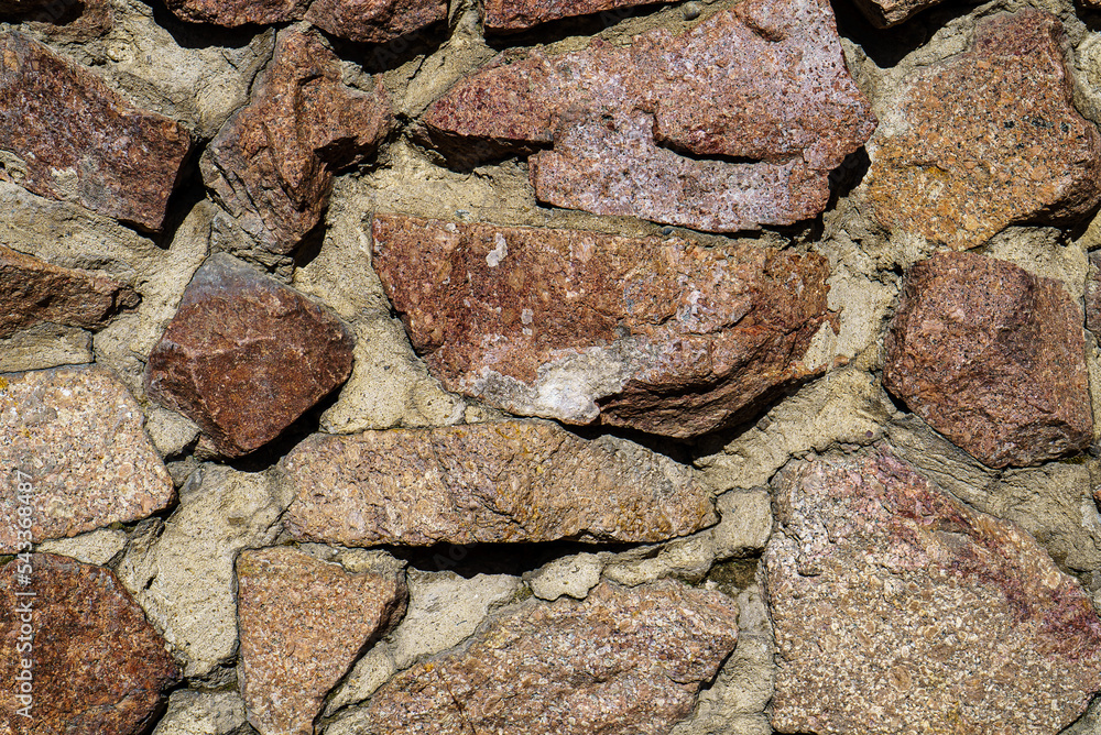 Fragment of a wall from a large granite. Ancient rock background Fragment of a wall from a large granite. Ancient rock background
