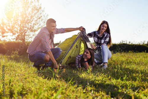 Group of young friends people preparing camping tent