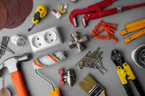 household hardware items. home improvement and repair. construction tools on gray background. top view photo