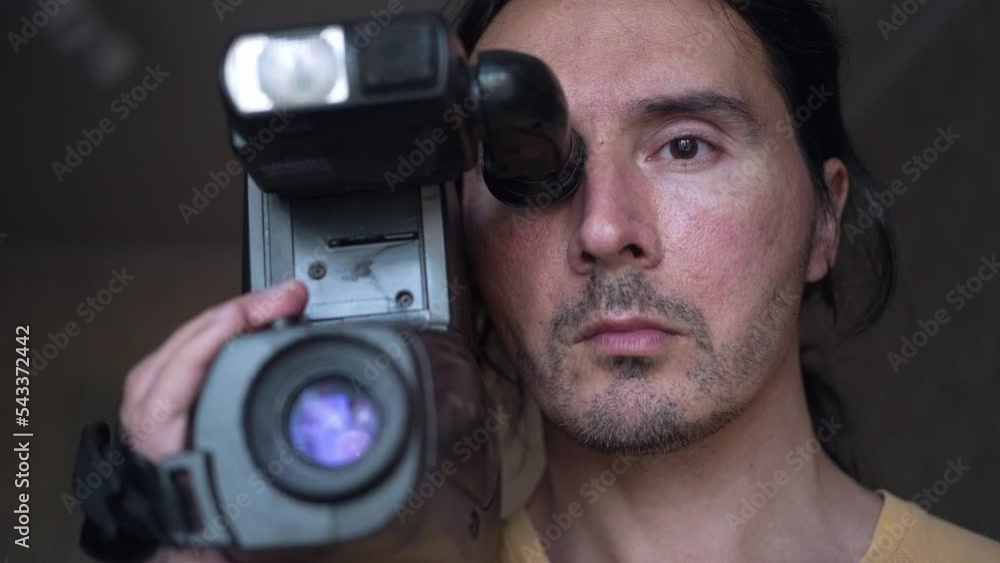 A handsome cameraman with a retro camcorder, man with camera. Slow motion A handsome cameraman with a retro camcorder, man with camera. Slow motion