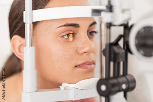 Vision, eyesight and woman gets ophthalmology eye exam with light on iris testing to see sight. Healthcare, medical insurance and eyes, girl getting healthy visual refraction eye test at clinic.