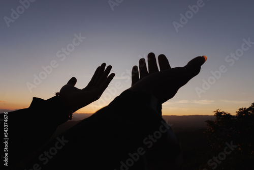 Silhouette of Human hands open palm up worship. Eucharist Therapy Bless God Helping Repent Catholic Easter Lent Mind Pray. Christian Religion concept background. fighting and victory for god.