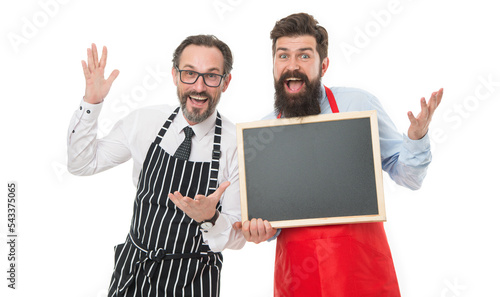 Culinary expert. catering business. welcome on board. cafe and restaurant opening. bearded men with blackboard, copy space. menu planning. happy chef team in apron. partners celebrate start up photo