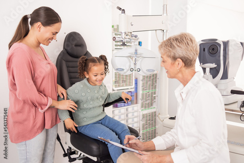 Consulting, mother and child with an eye doctor for healthy eyes, vision and retina wellness optical test. Smile, mom and happy girl at an optometrist with an optician writing results for an exam photo