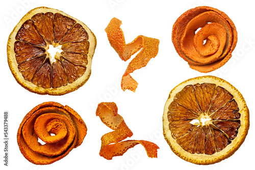 Round dried orange slices and twisted strips of orange peel close-up 