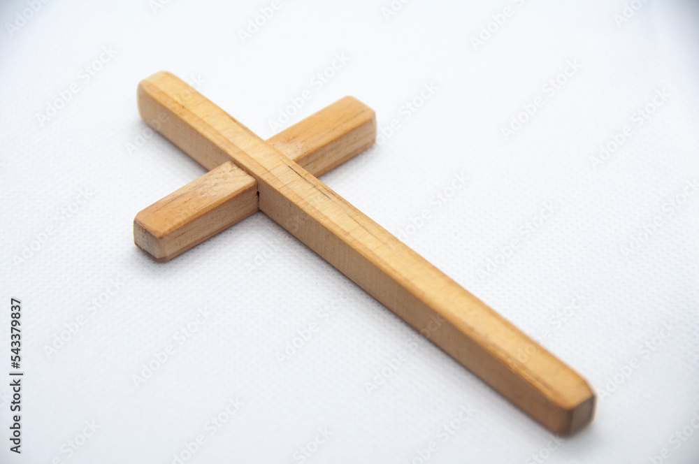 Wooden Cross on white cover background representing Good Friday, Lent Season and Holy Week concept. Wooden Cross on white cover background representing Good Friday, Lent Season and Holy Week concept.