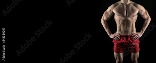 cropped view of fitness man abs. muscular abs of fitness man isolated on black background. © be free