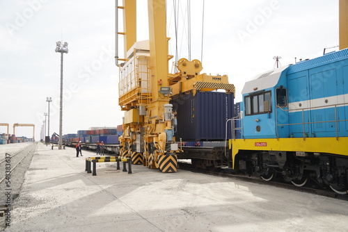 Khorgos, Kazakhstan - 09.22.2022 : Unloading of cargo containers in the dry port of Khorgos. photo