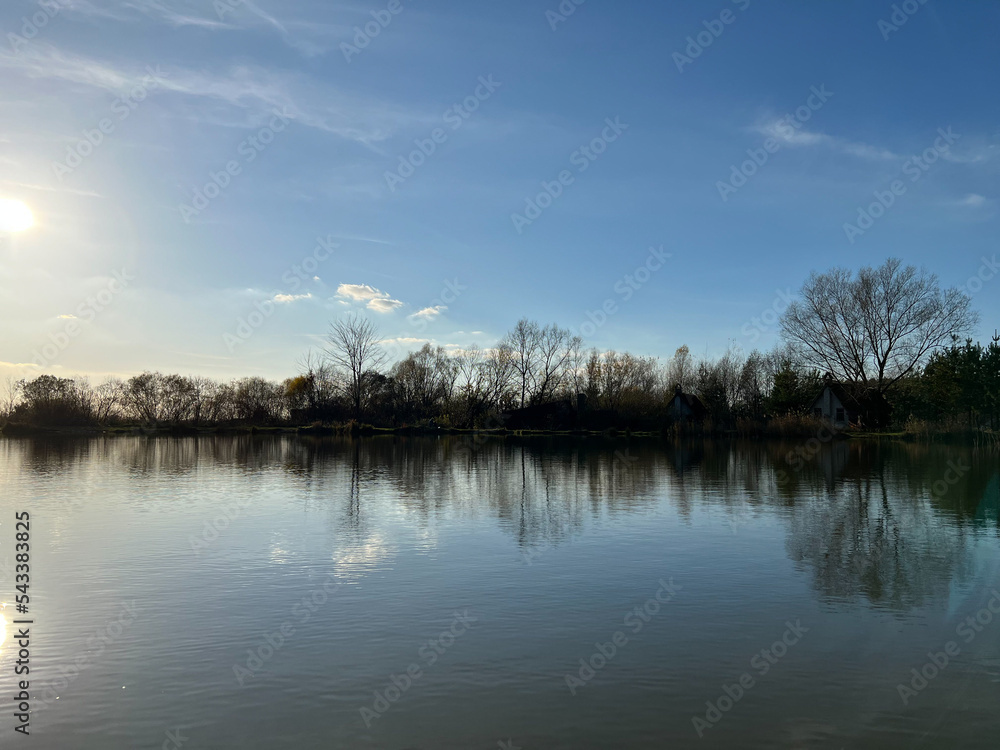 Autumn mood landscape with lake and forest in the perfect sunny weather